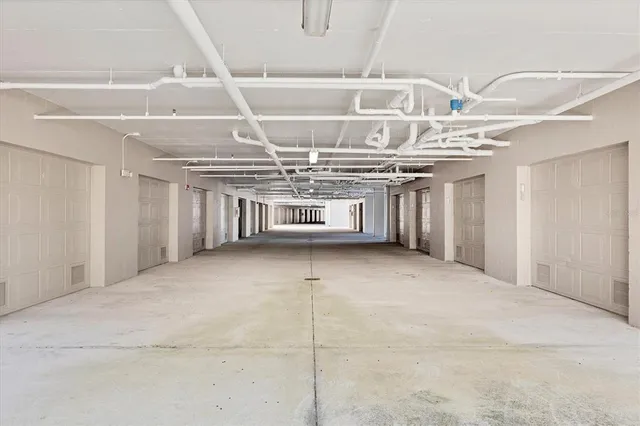 a sign that is sitting in front of a house with a big yard