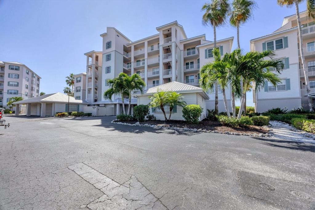 13313 Gasparilla Road, Unit 202 Placida, FL 33946 - Photo 7 of 57 a palm tree in front of a building