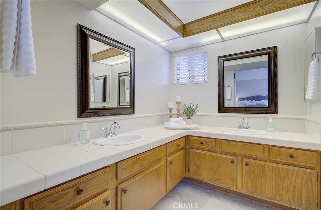 26809 Cold Springs Street Calabasas, CA 91301 - Photo 21 of 33 a bathroom with a sink and two mirror