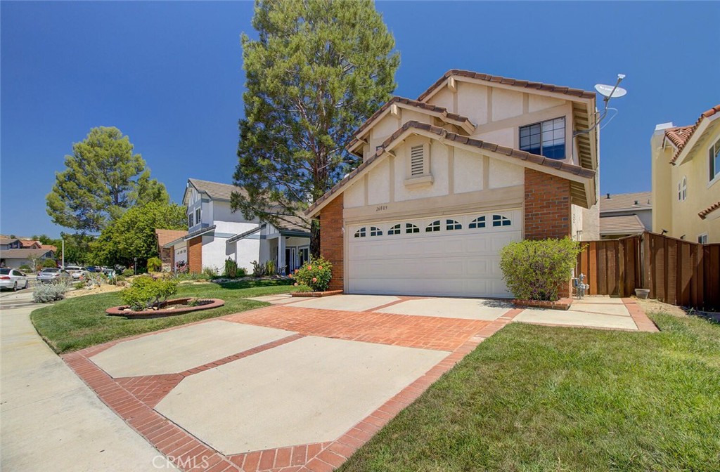 26809 Cold Springs Street Calabasas, CA 91301 - Photo 3 of 33 a view of a white house with a yard and table and chairs under an umbrella