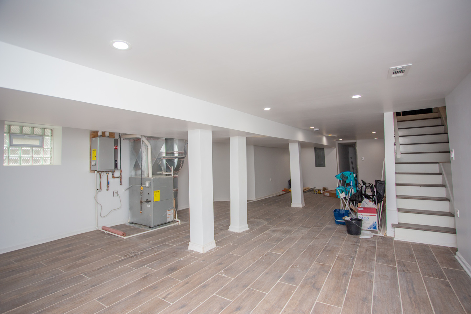 8810 South Morgan Street Chicago, IL 60620 - Photo 15 of 18 an empty room with wooden floor staircase and windows