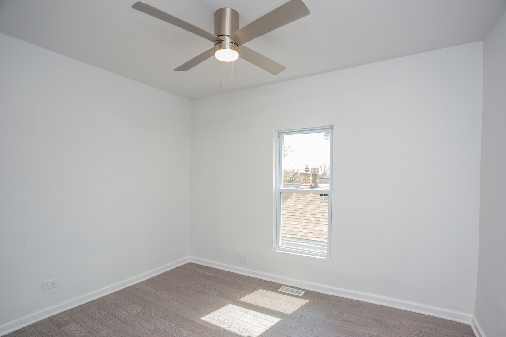 8810 South Morgan Street Chicago, IL 60620 - Photo 9 of 18 an empty room with a window and a fan