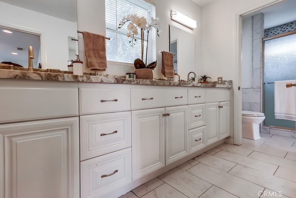15302 Doty Avenue Lawndale, CA 90260 - Photo 15 of 26 a bathroom with a double vanity sink and a mirror