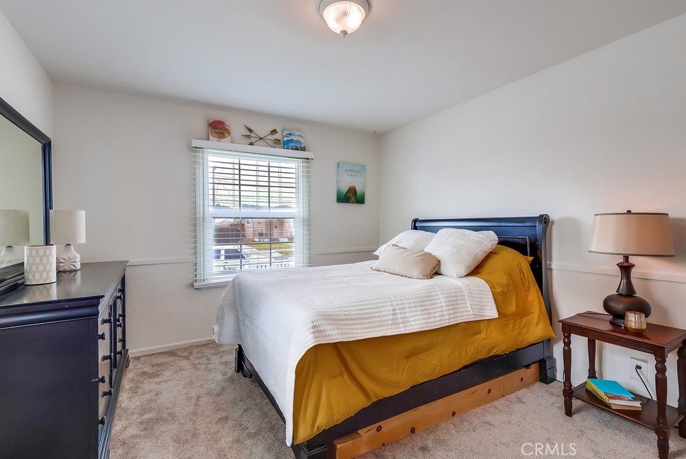 15302 Doty Avenue Lawndale, CA 90260 - Photo 19 of 26 a bedroom with a bed and a lamp on table