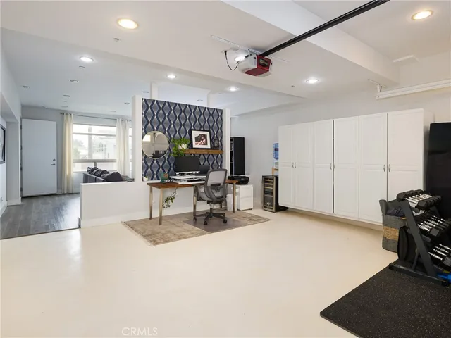 a view of a livingroom with workspace and a large window