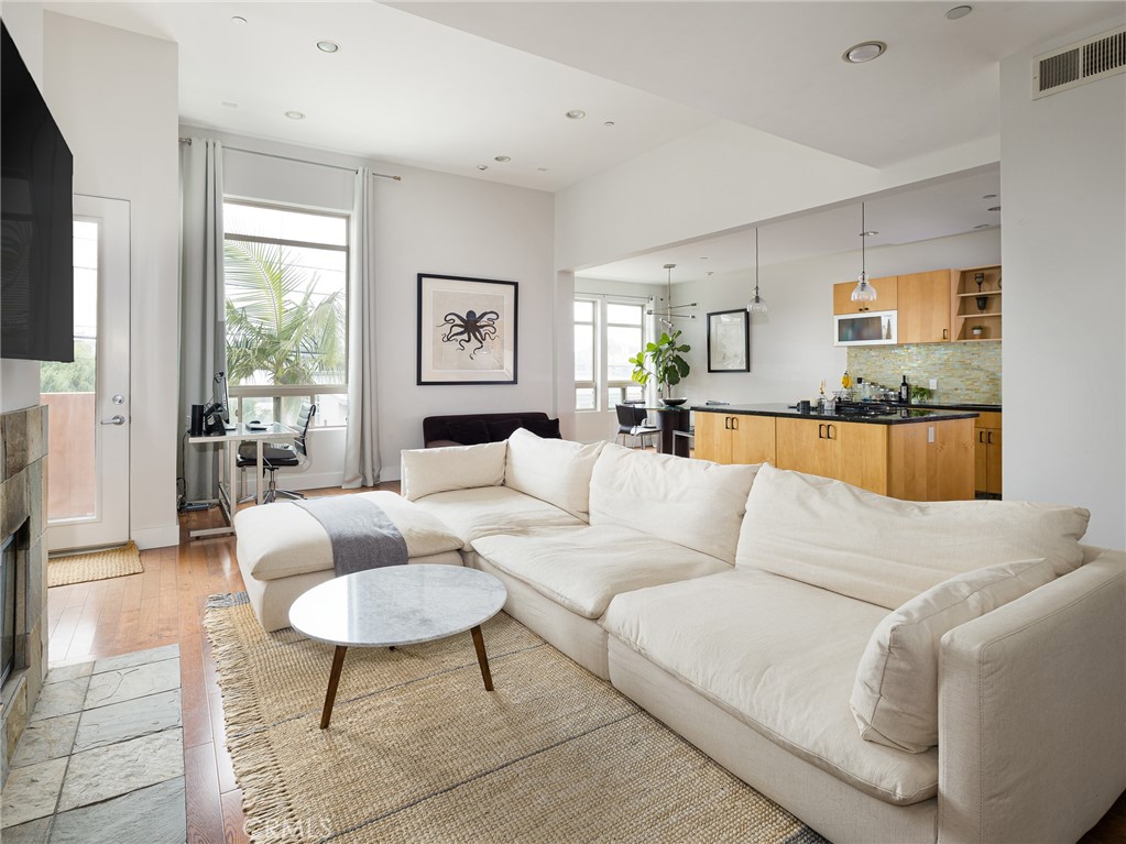 1225 East Grand Avenue, Unit B El Segundo, CA 90245 - Photo 2 of 21 a living room with furniture and a large window