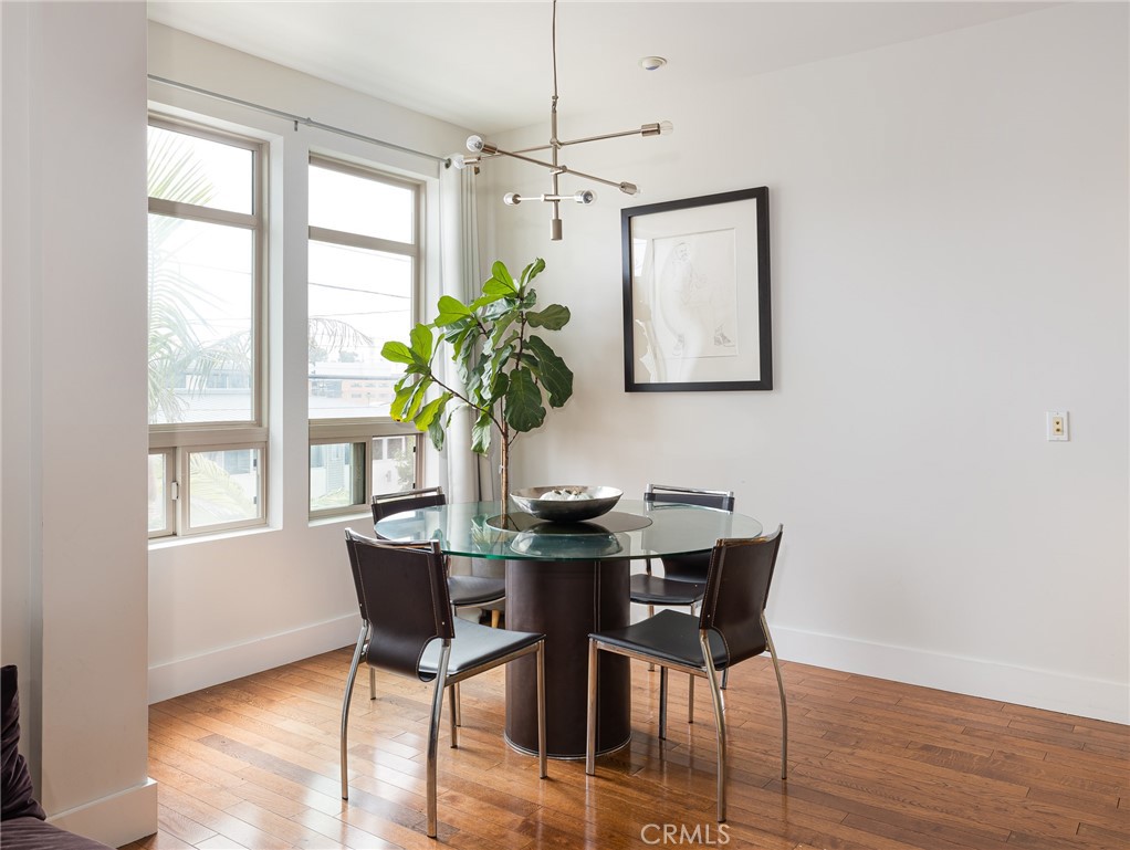 1225 East Grand Avenue, Unit B El Segundo, CA 90245 - Photo 6 of 21 a view of a dining room with furniture window and wooden floor