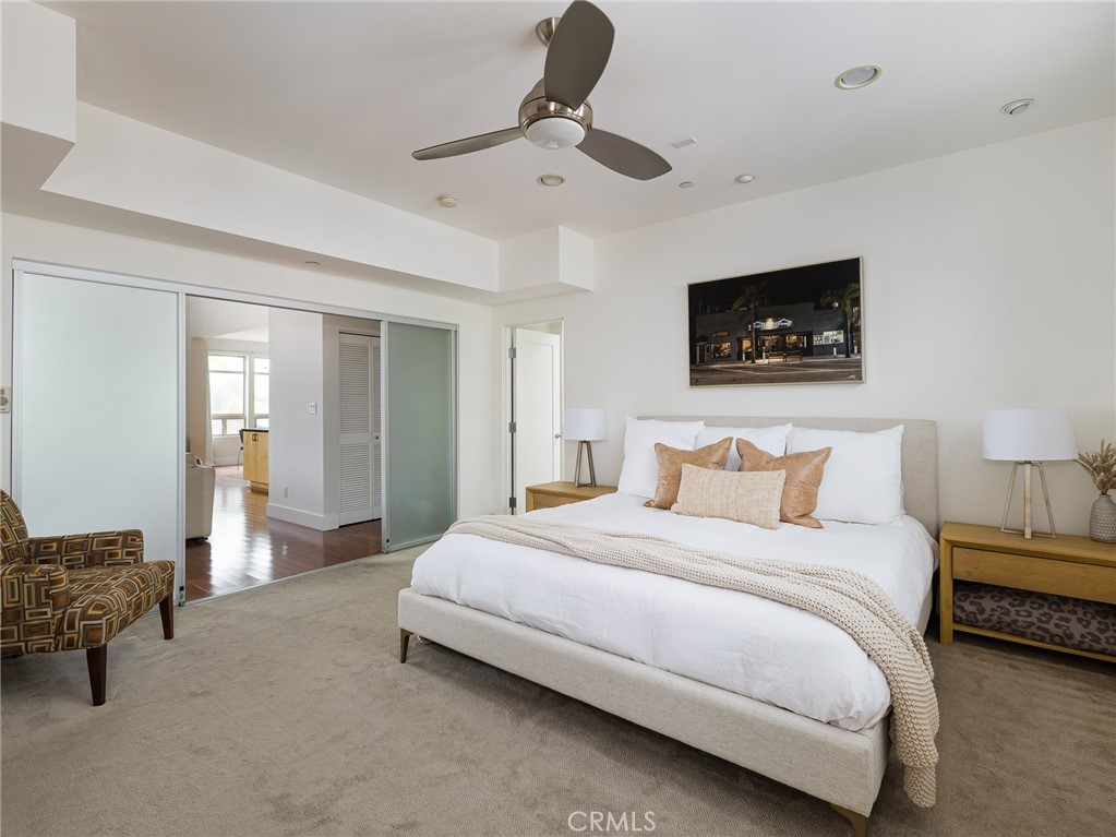 1225 East Grand Avenue, Unit B El Segundo, CA 90245 - Photo 8 of 21 a bedroom with bed and a chandelier