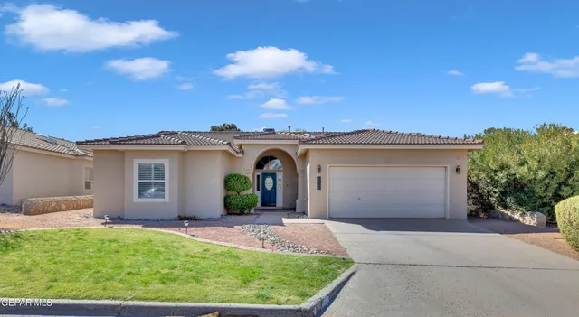 a view of a house with a yard and plants