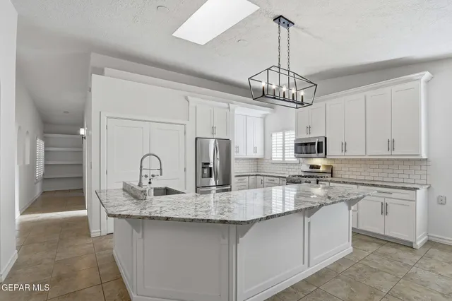 a bathroom with a granite countertop sink a mirror and a shower