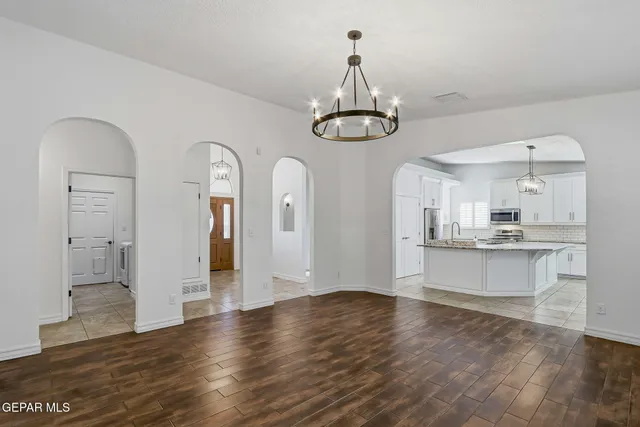 a kitchen with stainless steel appliances granite countertop a sink dishwasher and white cabinets with a granite countertops