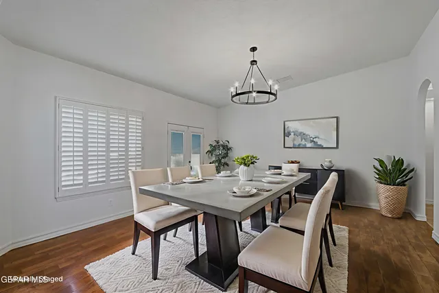 a kitchen with granite countertop white cabinets and stainless steel appliances