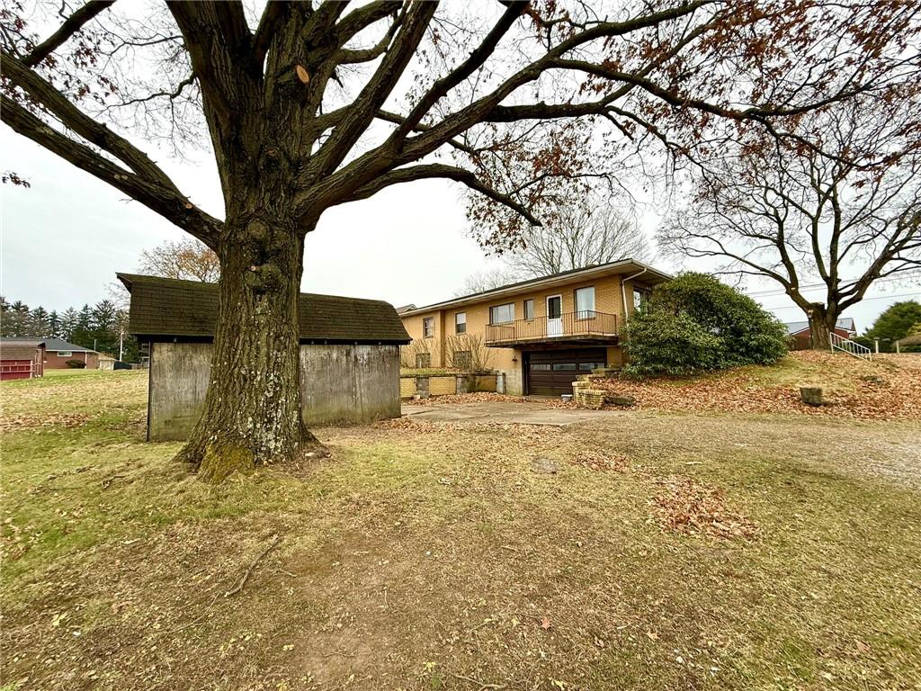 119 Pine Run Church Road Apollo, PA 15613 - Photo 19 of 20 a yellow house with trees in front of it
