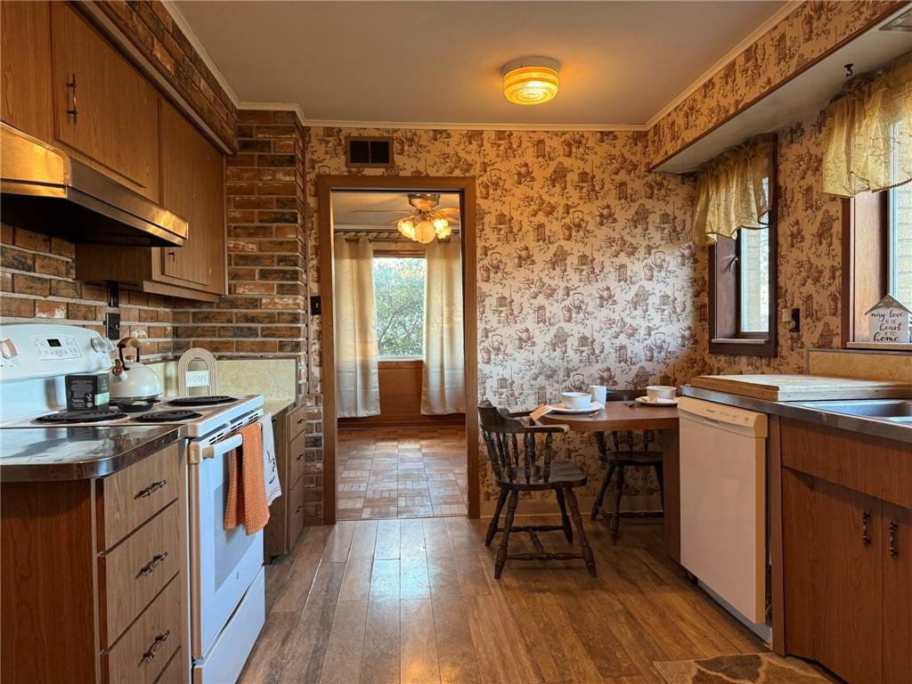 119 Pine Run Church Road Apollo, PA 15613 - Photo 8 of 20 a kitchen with stainless steel appliances granite countertop a stove a sink dishwasher and cabinets with wooden floor