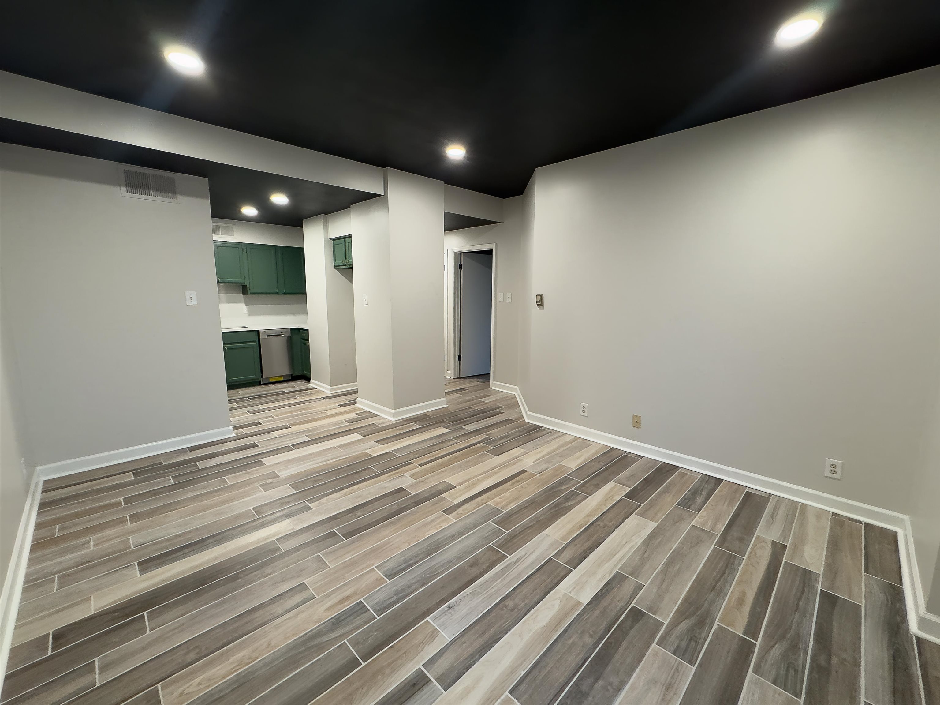 109 North Main Street, Unit 907 Memphis, TN 38103 - Photo 11 of 29 Open-concept living area featuring wood-finish tile flooring, recessed lighting, and a neutral wall palette