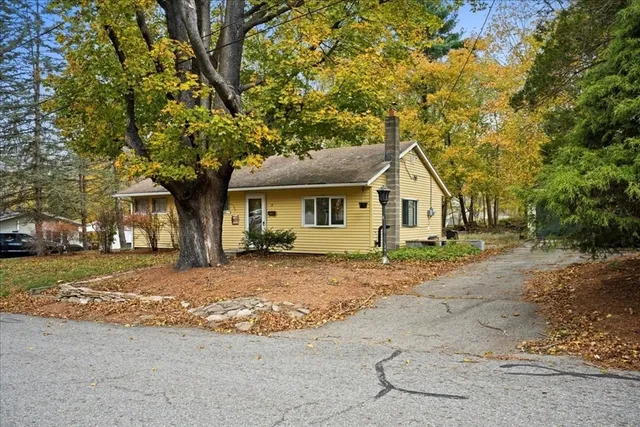 a view of a house with a tree in the background