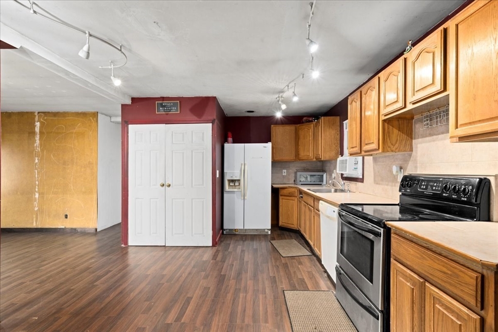 2 Sunset Lane Spencer, MA 01562 - Photo 21 of 37 a large kitchen with stainless steel appliances granite countertop a stove and a refrigerator