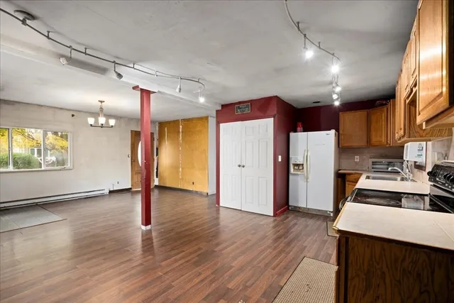 a kitchen with a refrigerator a sink and dishwasher with wooden cabinets
