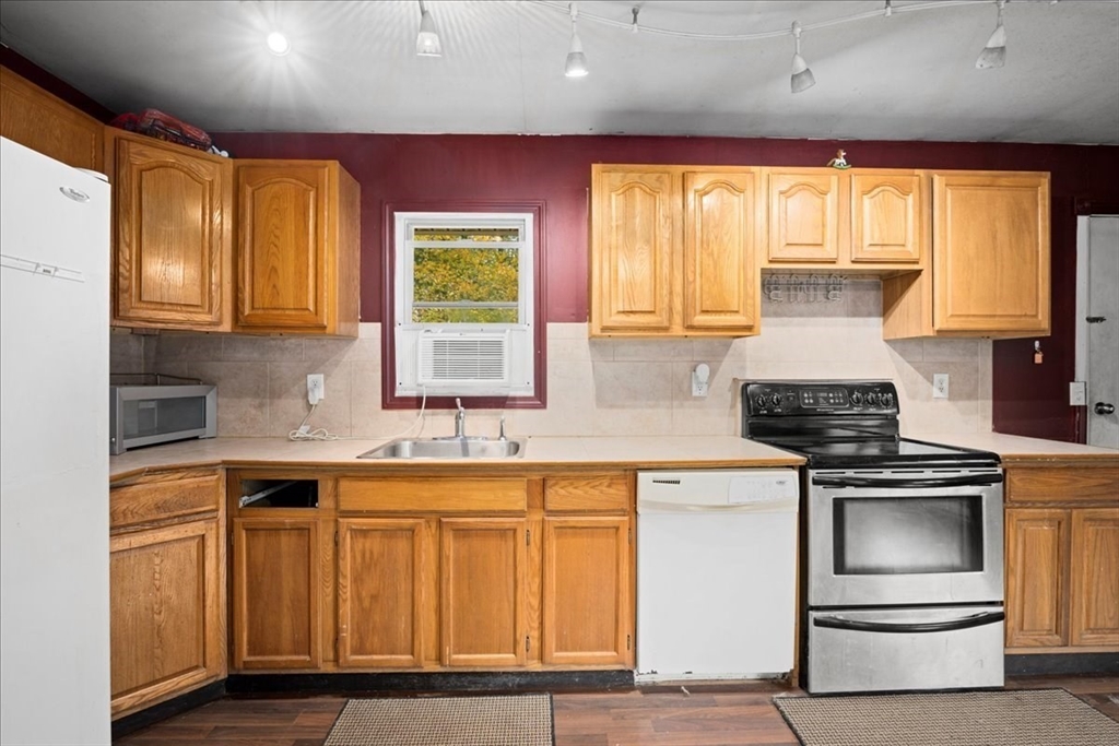 2 Sunset Lane Spencer, MA 01562 - Photo 24 of 37 a kitchen with stainless steel appliances granite countertop a stove a sink and a microwave