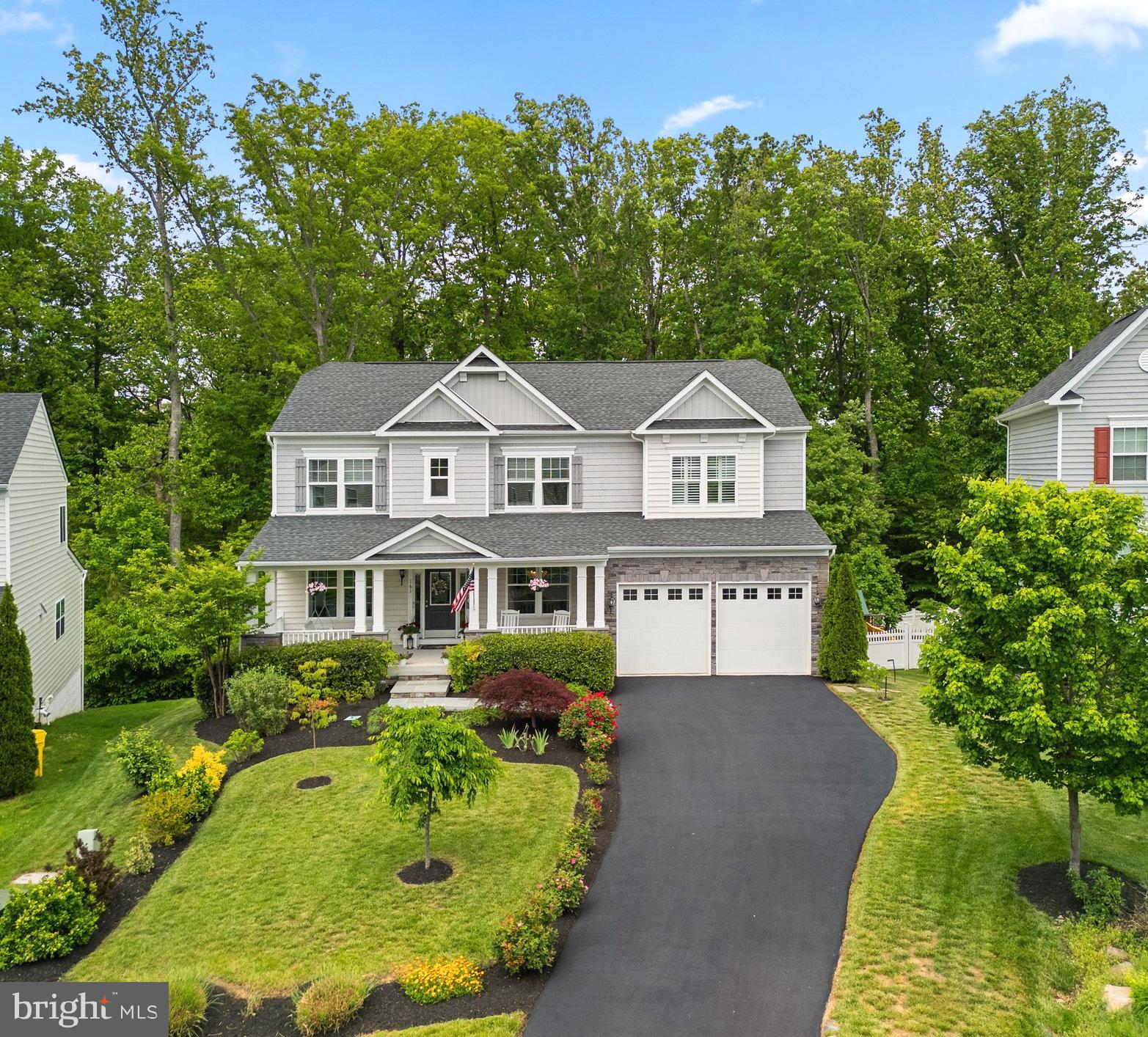 a front view of a house with a garden and plants