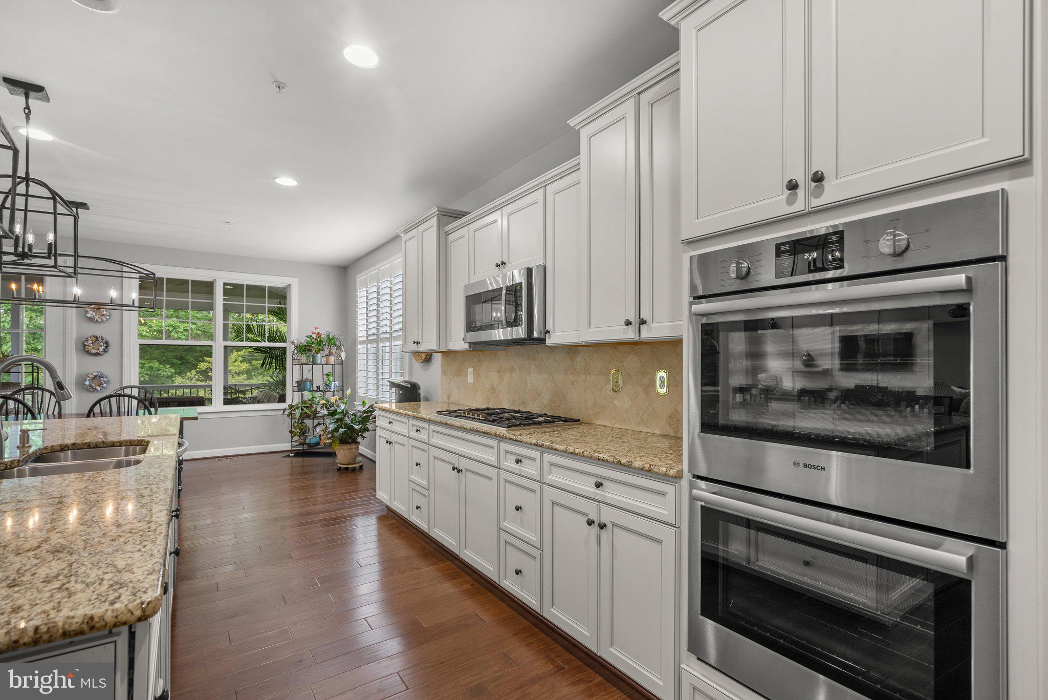 161 Moore Road Arnold, MD 21012 - Photo 17 of 57 a kitchen with granite countertop a stove and white cabinets