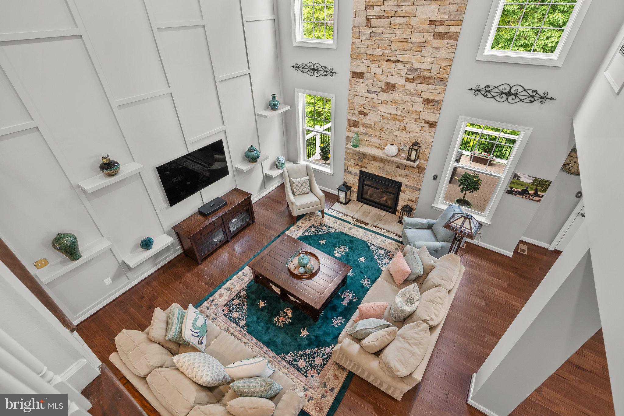 161 Moore Road Arnold, MD 21012 - Photo 23 of 57 a living room with furniture a fireplace a flat screen tv and a window