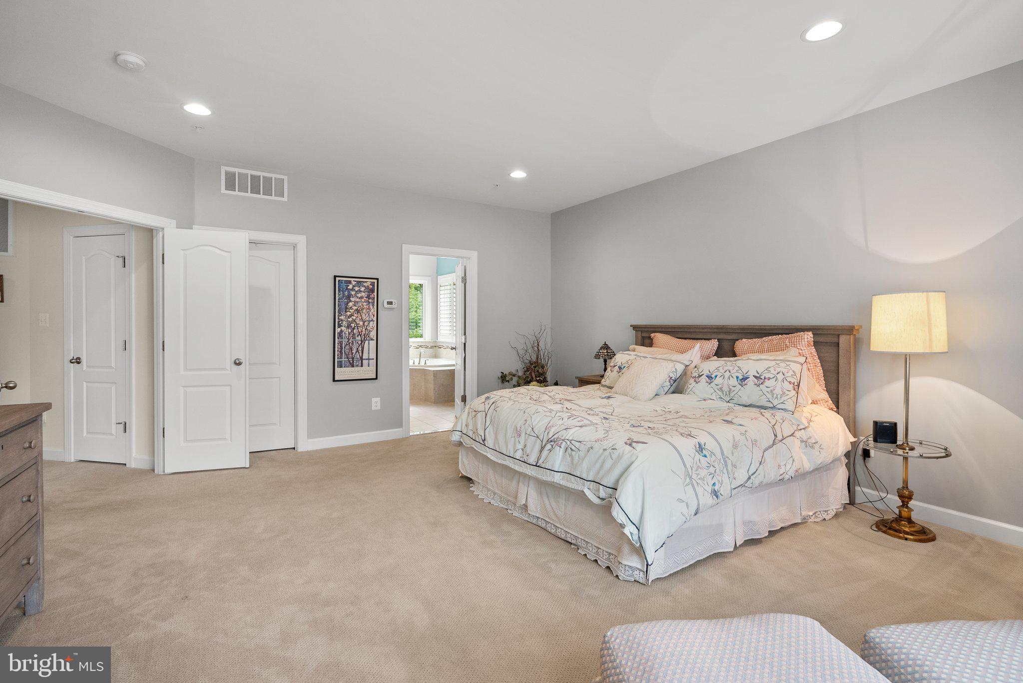 161 Moore Road Arnold, MD 21012 - Photo 25 of 57 a spacious bedroom with a bed and a lamp