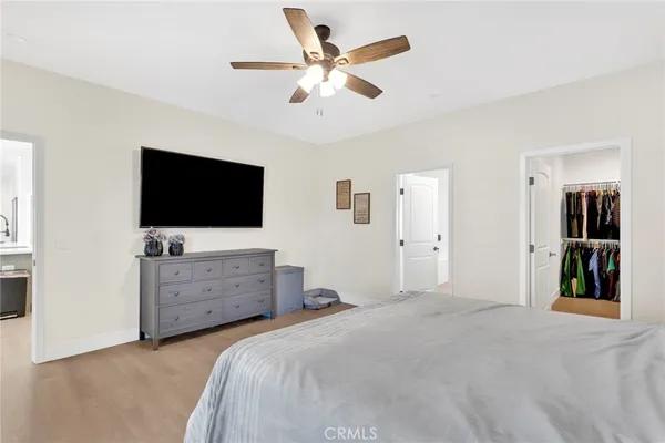 a bedroom with a bed and a flat screen tv in dresser