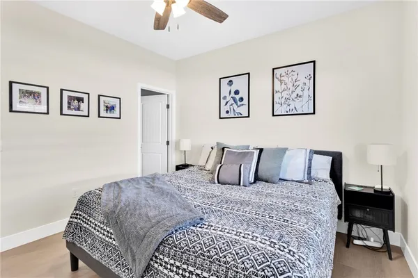 a large bedroom with a bed and wooden floor