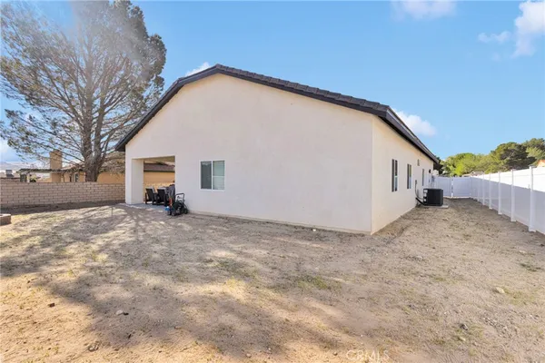 a view of house with backyard and trees