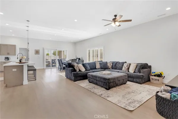 a living room with furniture and a ceiling fan
