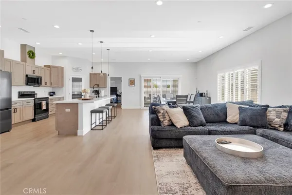 a living room with furniture and kitchen view
