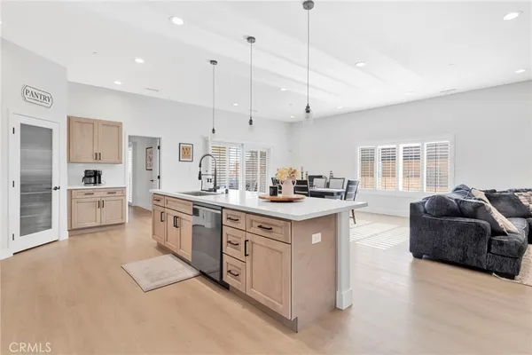 a kitchen with stainless steel appliances kitchen island granite countertop a sink a stove and a refrigerator