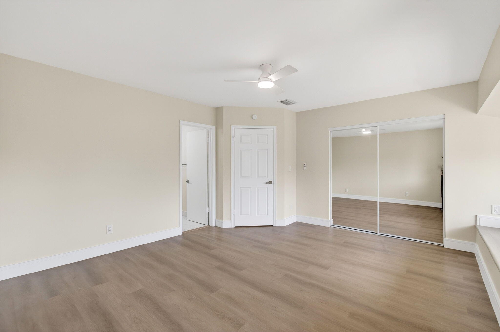 1330 Northwest 13th Street, Unit 12 Boca Raton, FL 33486 - Photo 36 of 52 an empty room with wooden floor and bathroom space