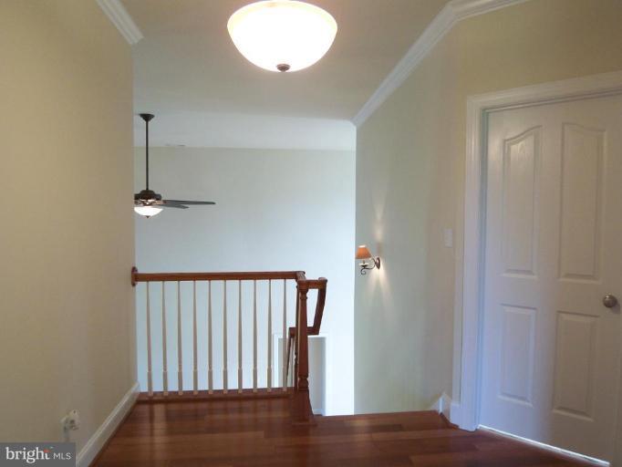 20047 Middletown Road Freeland, MD 21053 - Photo 22 of 25 a view of hallway with stairs and wooden floor