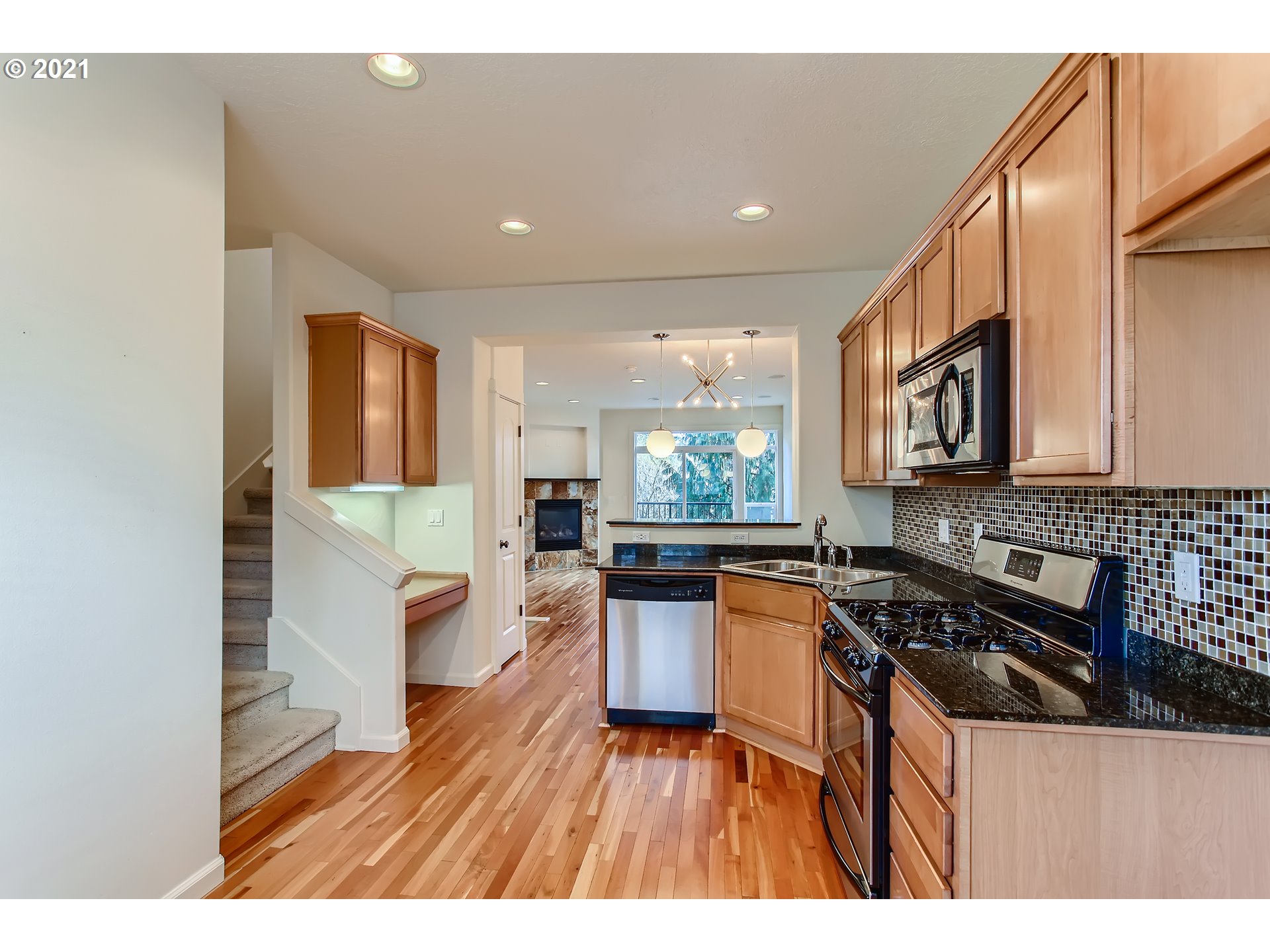3621 Southwest Innovation Court Beaverton, OR 97003 - Photo 8 of 32 a kitchen with a stove a sink and a microwave