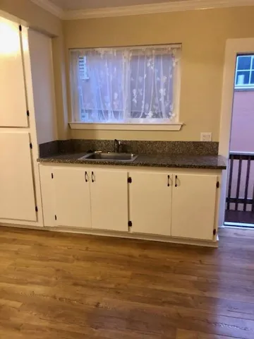 a view of a kitchen with wooden floor