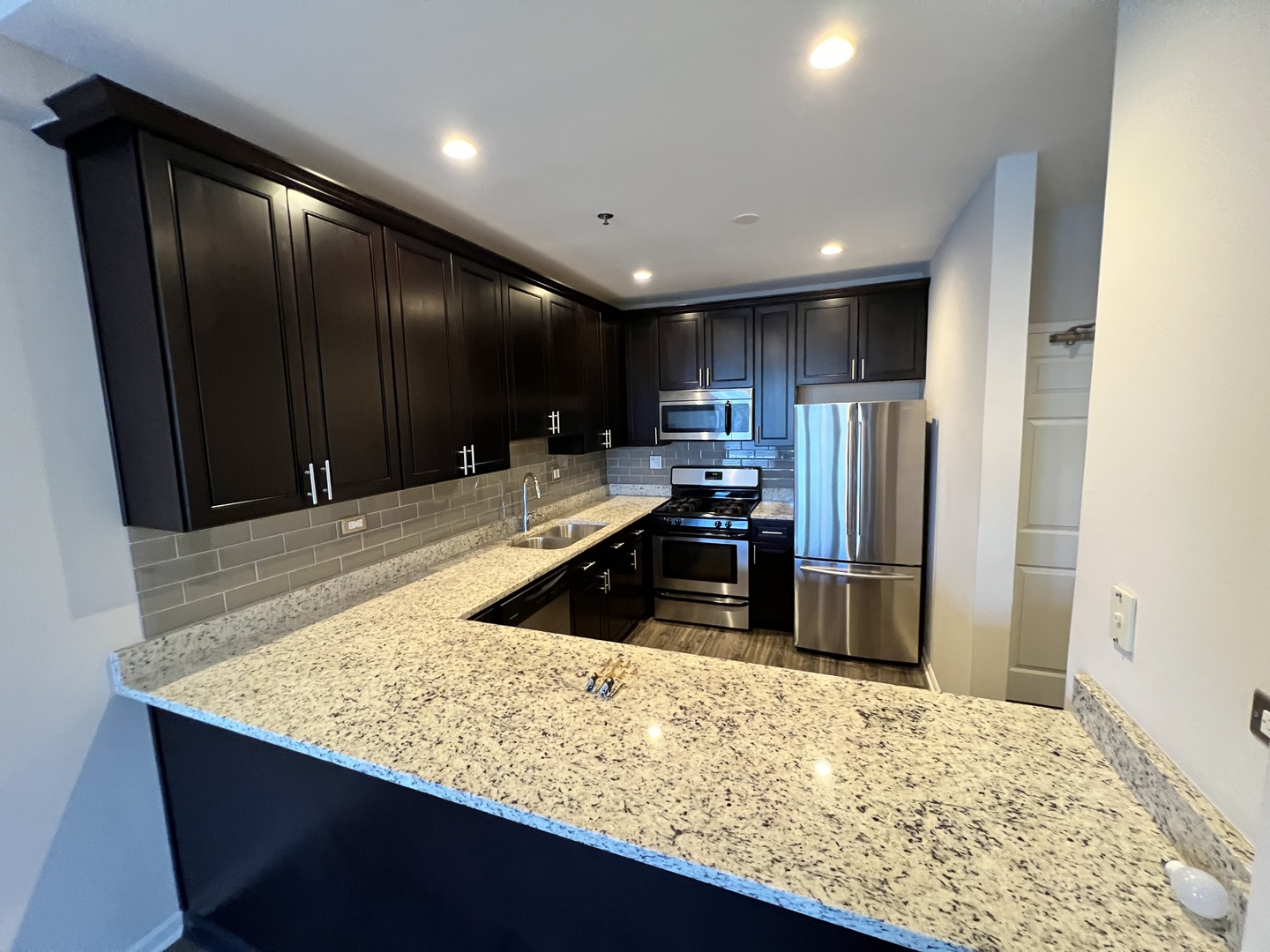625 Deerfield Road, Unit 307 Deerfield, IL 60015 - Photo 4 of 12 a kitchen with stainless steel appliances granite countertop sink and refrigerator