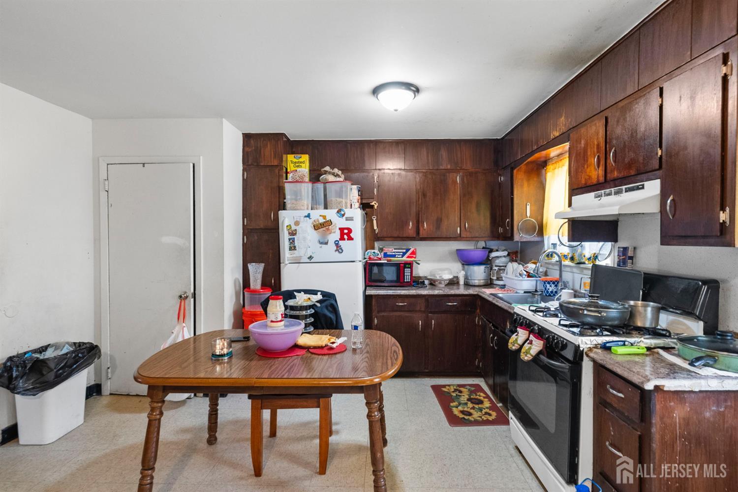 16 Millstone Road Somerset, NJ 08873 - Photo 11 of 35 a kitchen with a sink a stove and chairs