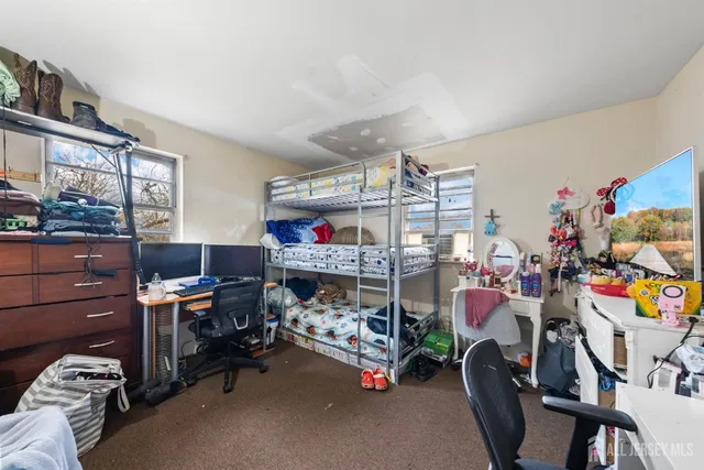 a bed room with a bed and a desk