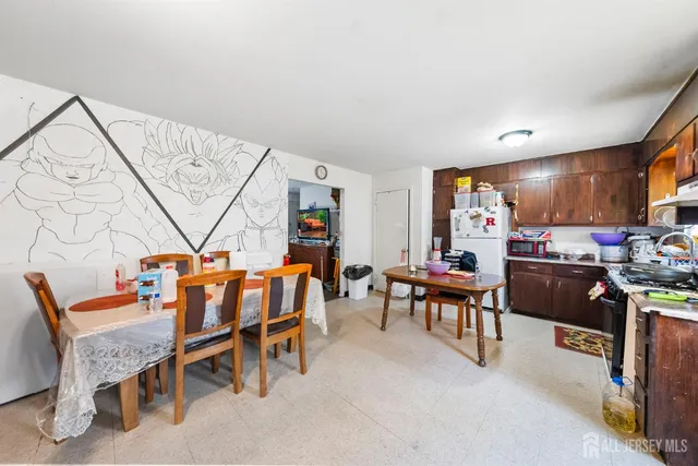 a kitchen with a sink a stove and chairs