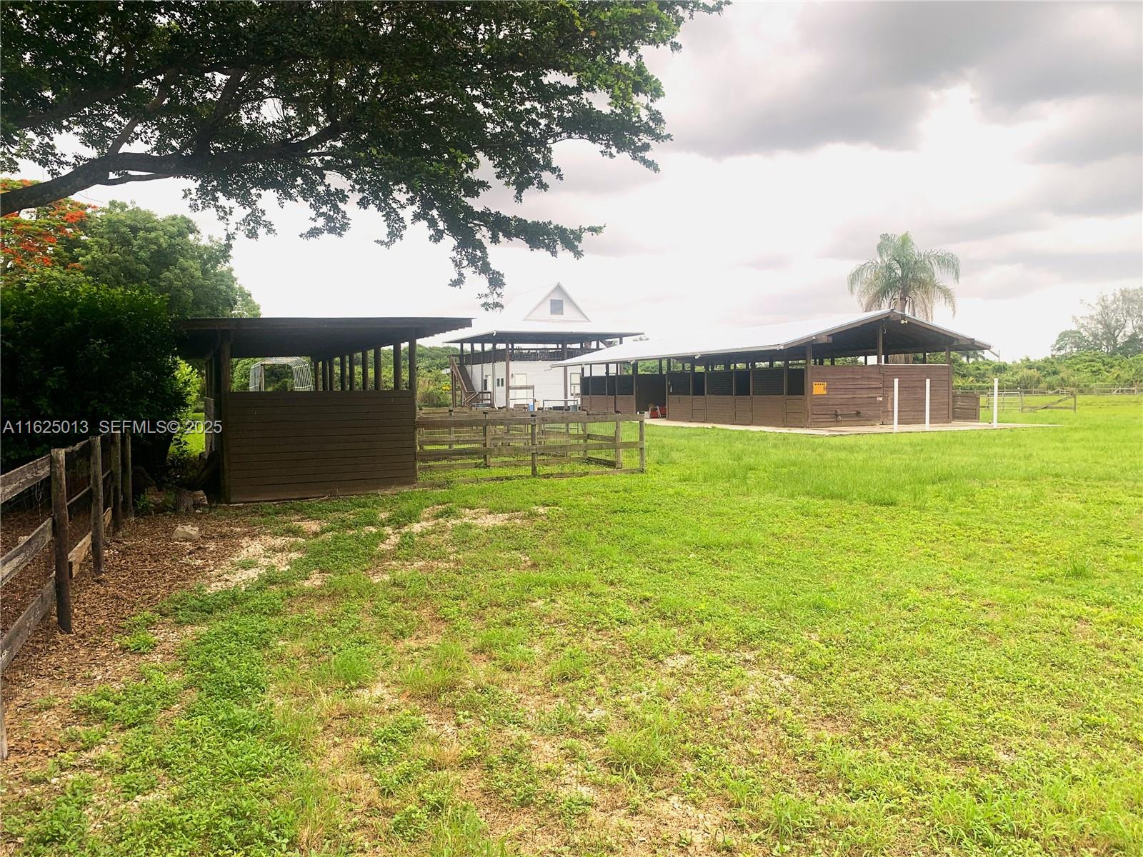 22750 Southwest 154th Avenue Miami, FL 33170 - Photo 25 of 37 a front view of a house with a yard
