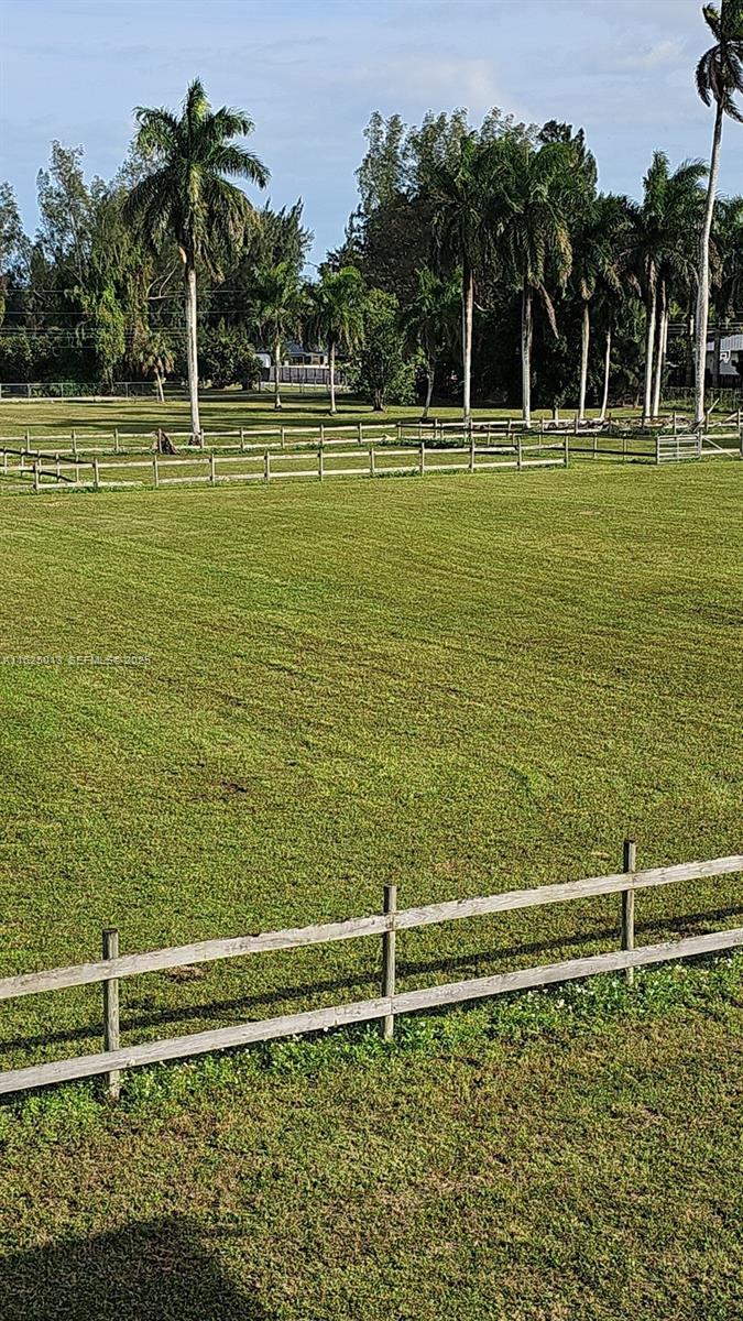 22750 Southwest 154th Avenue Miami, FL 33170 - Photo 37 of 37 a view of a swimming pool with a garden and trees