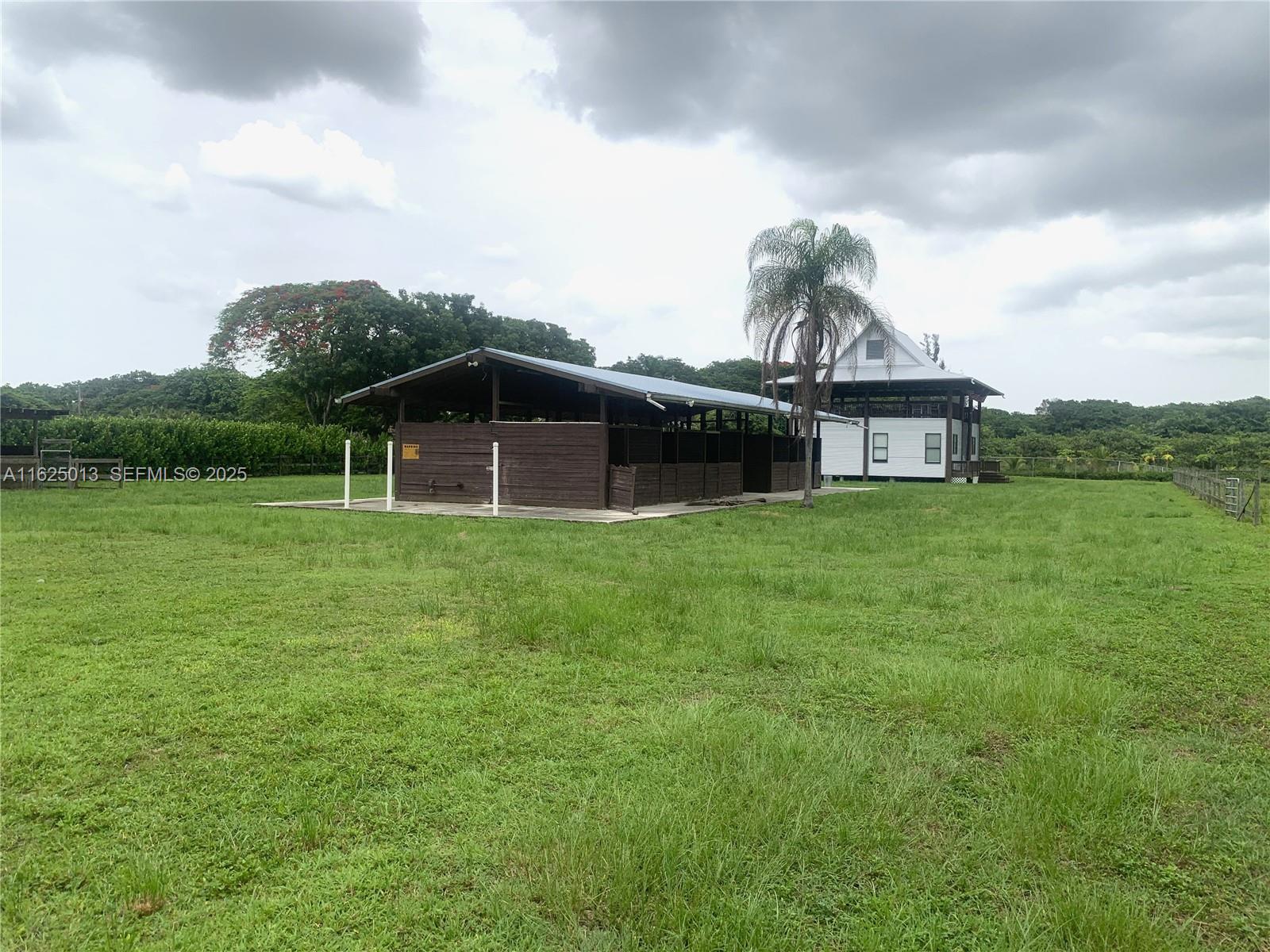 22750 Southwest 154th Avenue Miami, FL 33170 - Photo 6 of 37 a view of a house with a yard and sitting area