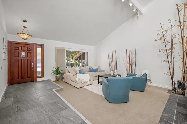 a living room with patio furniture and a ceiling fan