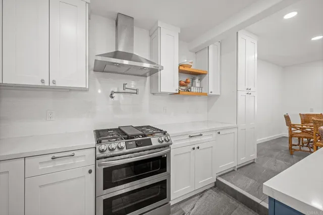 a dining room with furniture and a floor to ceiling window