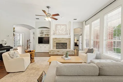 a living room with fireplace furniture and a large window