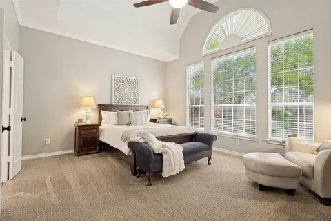 a bedroom with bed and a large window