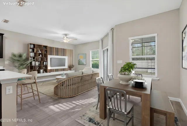 a living room with furniture a flat screen tv and a large window