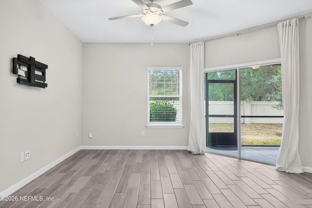 wooden floor in an empty room with a window